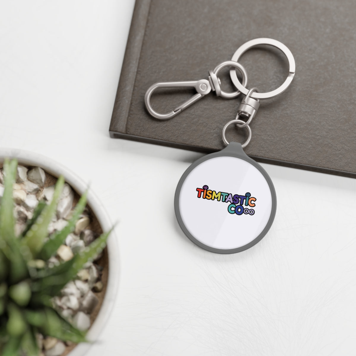 Color OG Tismtastic Logo Keyring Tag — White background Round Metal Keychain with Carabiner Clip
